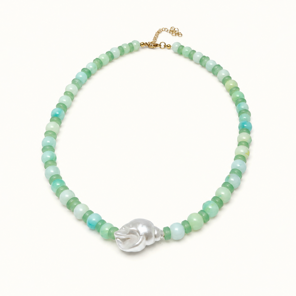 A beaded necklace featuring light green and turquoise-blue round beads, accented by a central silver-toned skull charm and a gold-tone clasp, displayed on a clean white background.